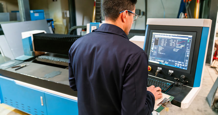 Technician servicing a customers need for their CNC System.